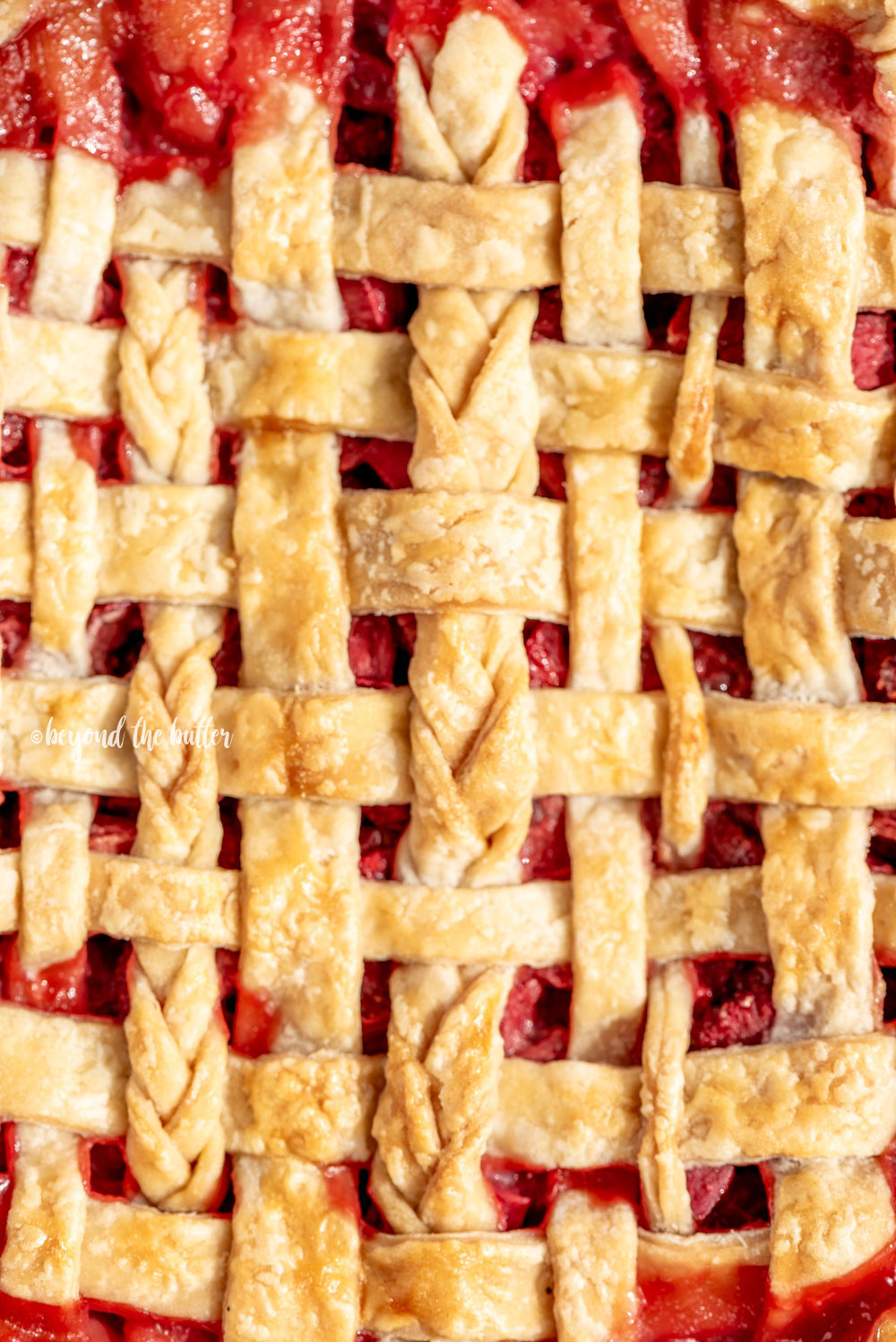 Close up image of lattice strawberry rhubarb pie crust.