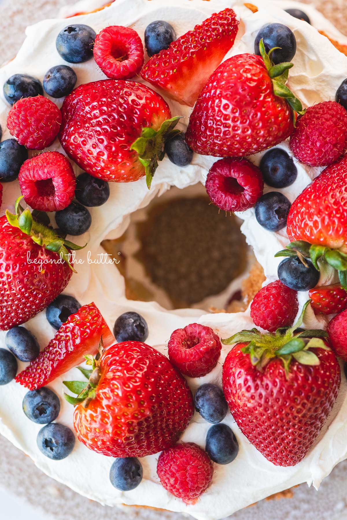 Homemade angel food cake with berries cloeup image | © Beyond the Butter®