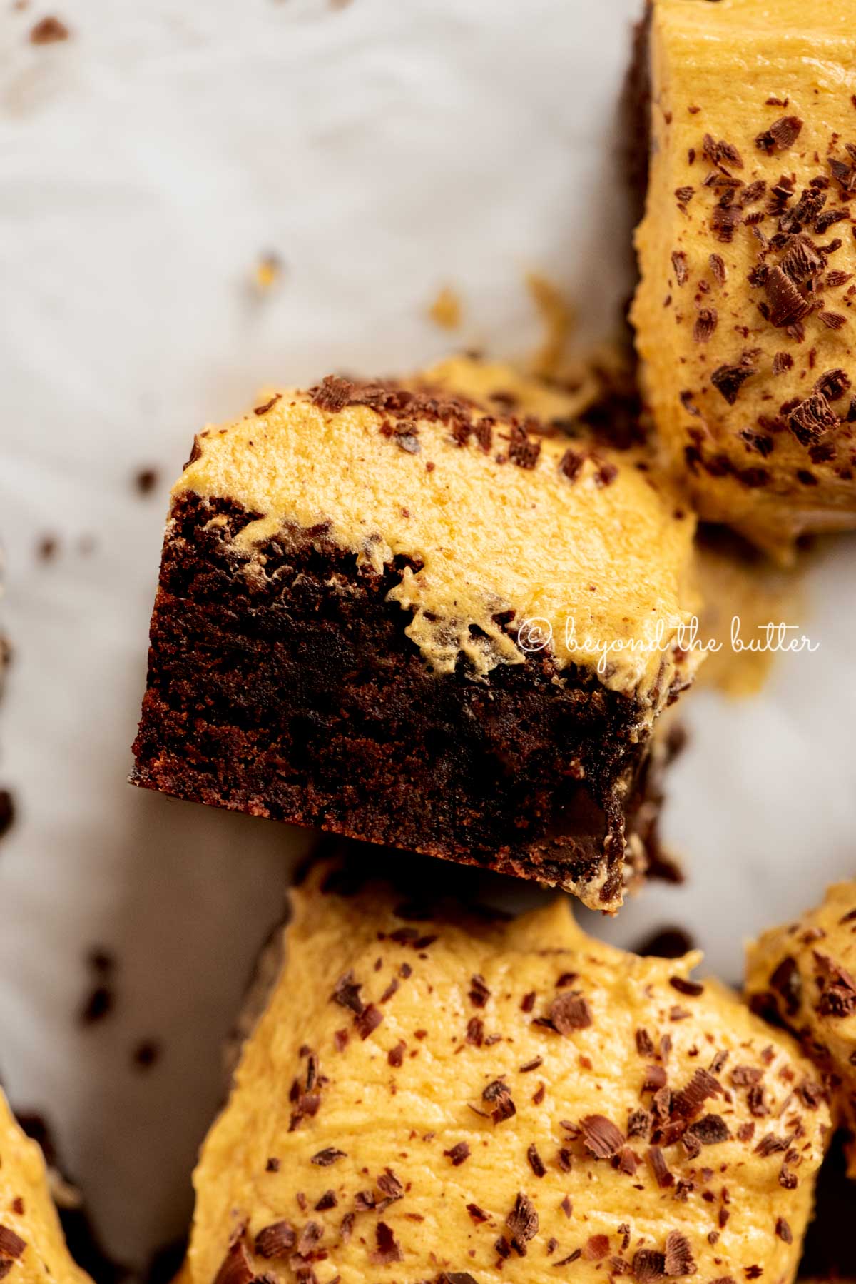 closeup of pumpkin frosted brownie on its side | All Images © Beyond the Butter™