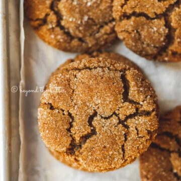 Overhead image of soft molasses sugar cookies on a parchment paper lined baking sheet | All Images © Beyond the Butter™