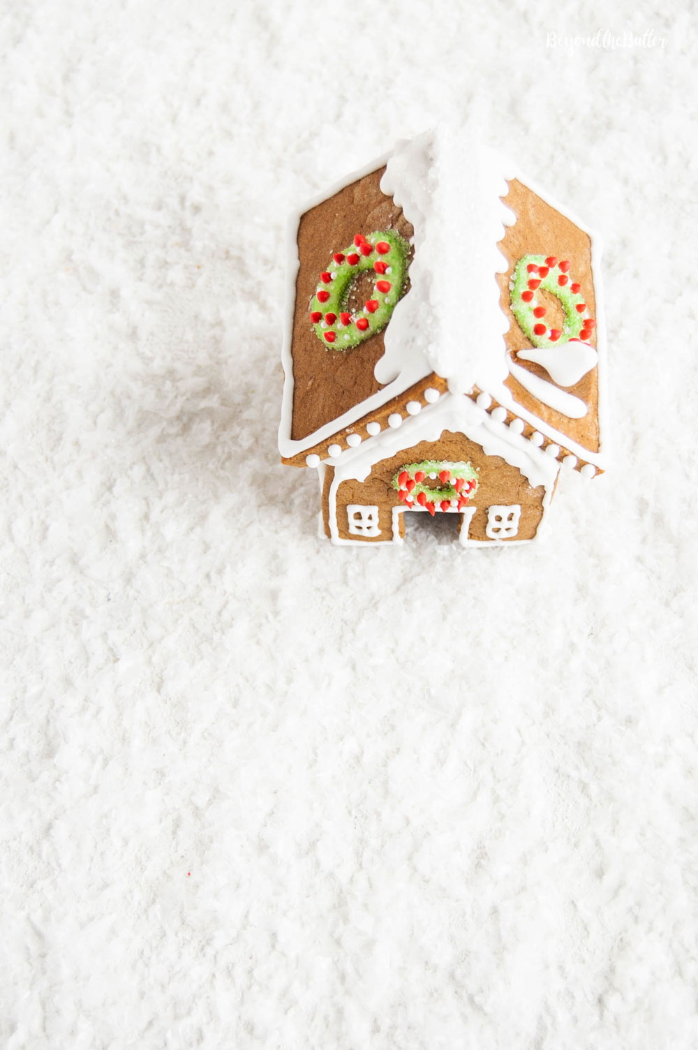 Homemade Gingerbread Houses - Overlooking the roof of one gingerbread house with wreaths on each side | All Images © Beyond the Butter, LLC