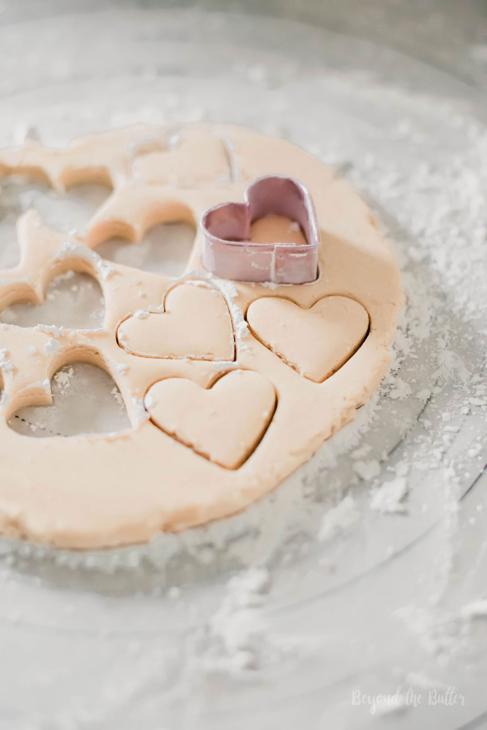 Chocolate Covered Peanut Butter Hearts | Cutting out peanut butter hearts with a small heart shaped cookie cutter | Image and Copyright Policy: Beyond the Butter, LLC