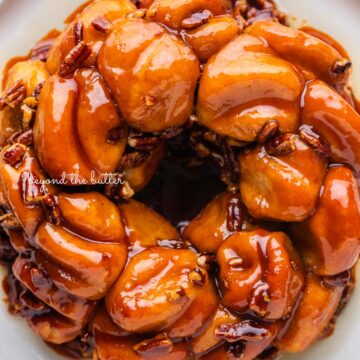 Overhead view of butterscotch bundt rolls on white dessert plate and white background | © Beyond the Butter®