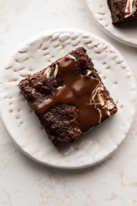 A single mint chocolate brownie on a small white dessert plate | © Beyond the Butter®
