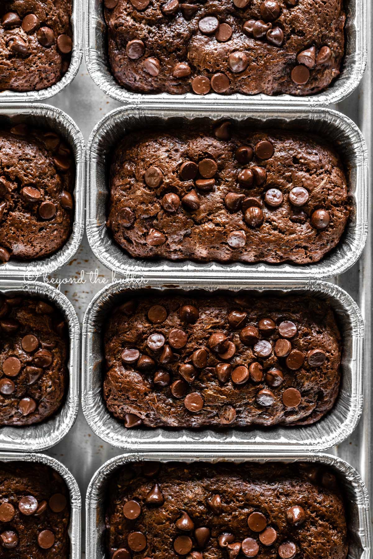 Overhead image of mini chocolate zucchini bread loaves | All Images © Beyond the Butter™