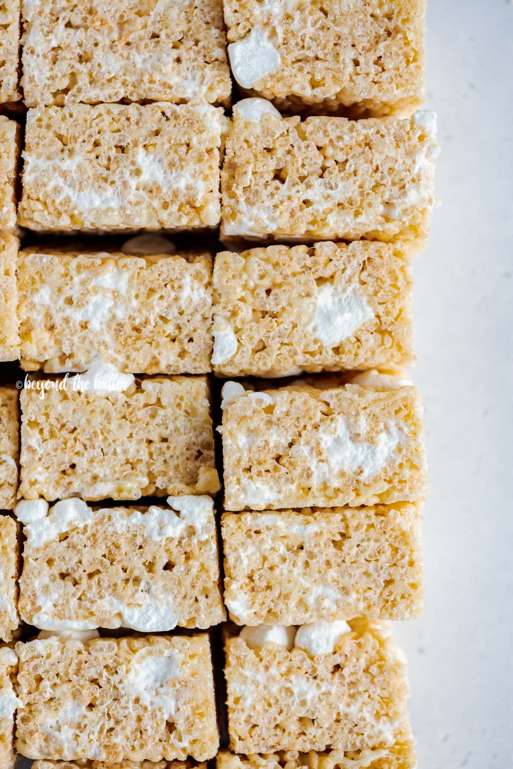 Overhead closeup image of the best rice krispie treats stacked and on their side | All Images © Beyond the Butter™