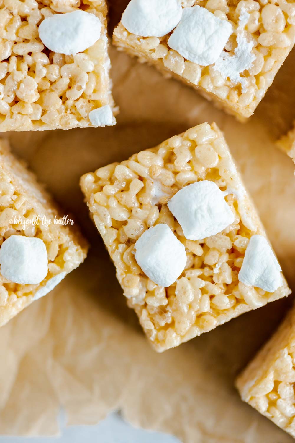 Overhead closeup image of the best rice krispie treats on parchment paper | All Images © Beyond the Butter™