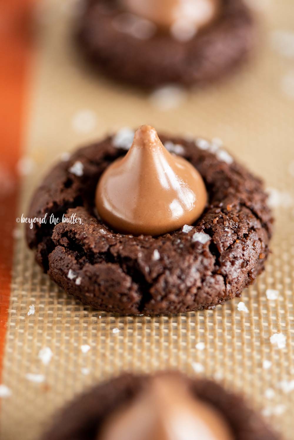 Angled image of Chocolate Caramel Blossoms on cookie sheet | All Images © Beyond the Butter, LLC