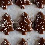 Chocolate Dipped Graham Cracker Chrismtas Trees on a wax paper lined cookie sheet.