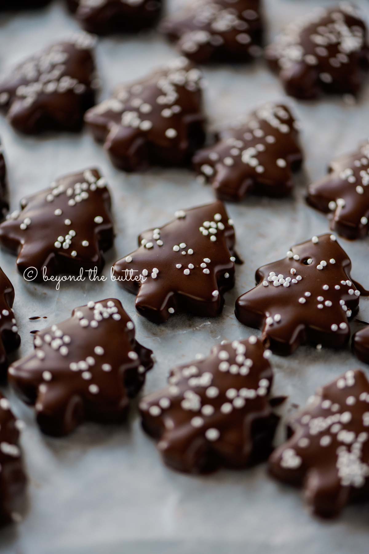 Chocolate Dipped Graham Cracker Chrismtas Trees on a cookie sheet | © Beyond the Butter®