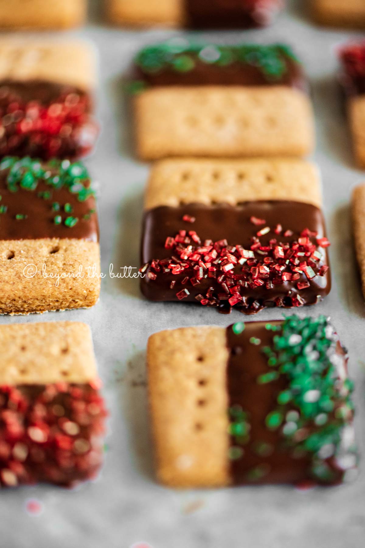 Close up image of Chocolate Dipped Graham Cracker Sqaures on a cookie sheet | © Beyond the Butter®