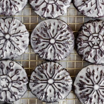 Overhead image of homemade oreo snowflake cookies on a wire cooling rack | All Images © Beyond the Butter®
