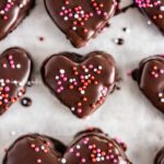 Overhead image of chocolate covered cookie dough hearts with sprinkles.