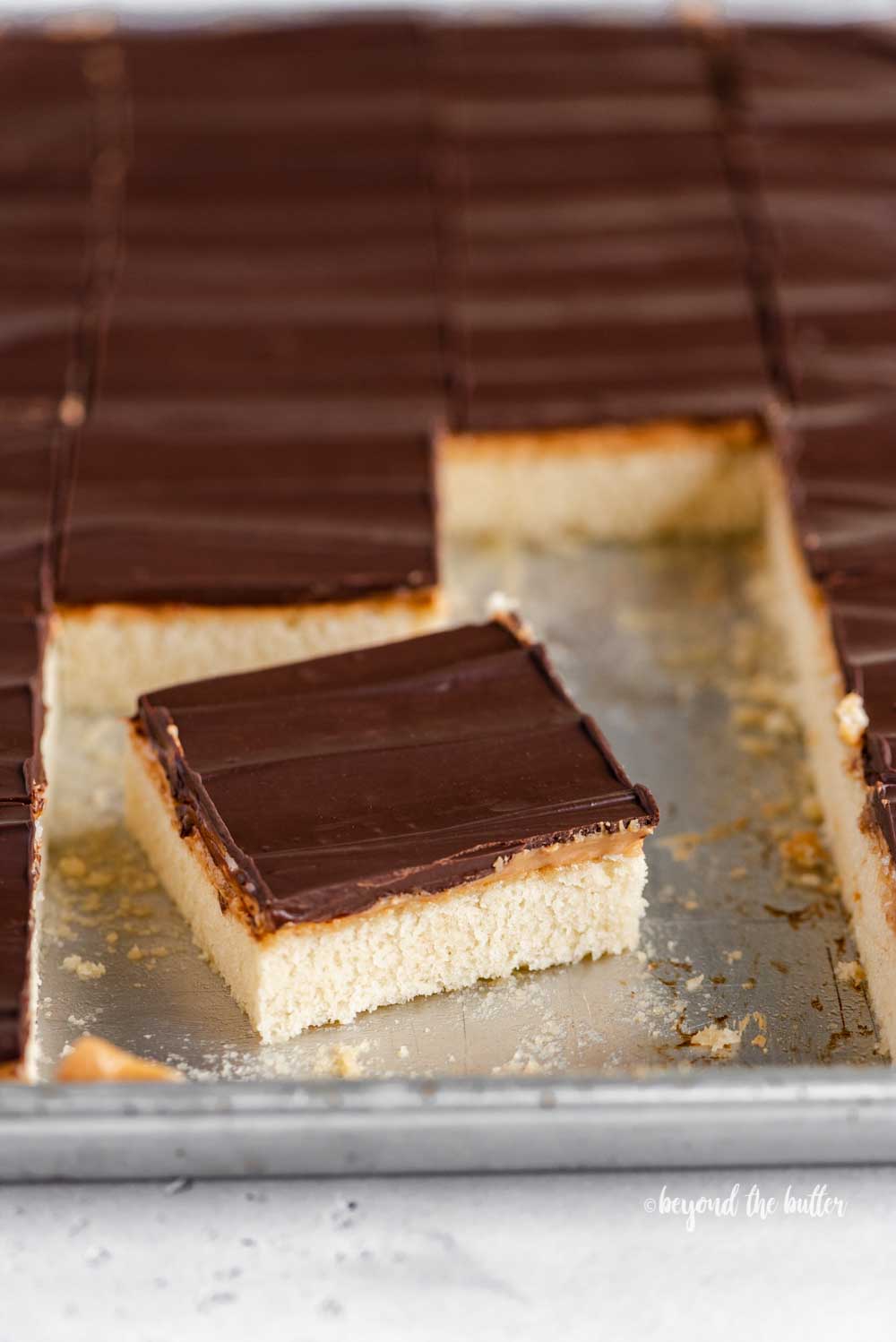 Angled image of cut irresistible peanut butter tandy kakes with one angled out from the rest | All Images © Beyond the Butter™