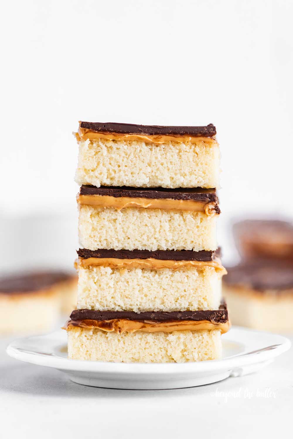 Image of stacked homemade peanut butter kandy kakes on a white dessert plate | All Images © Beyond the Butter™