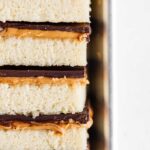 Closeup image of stacked homemade peanut butter kandy kakes on baking sheet.