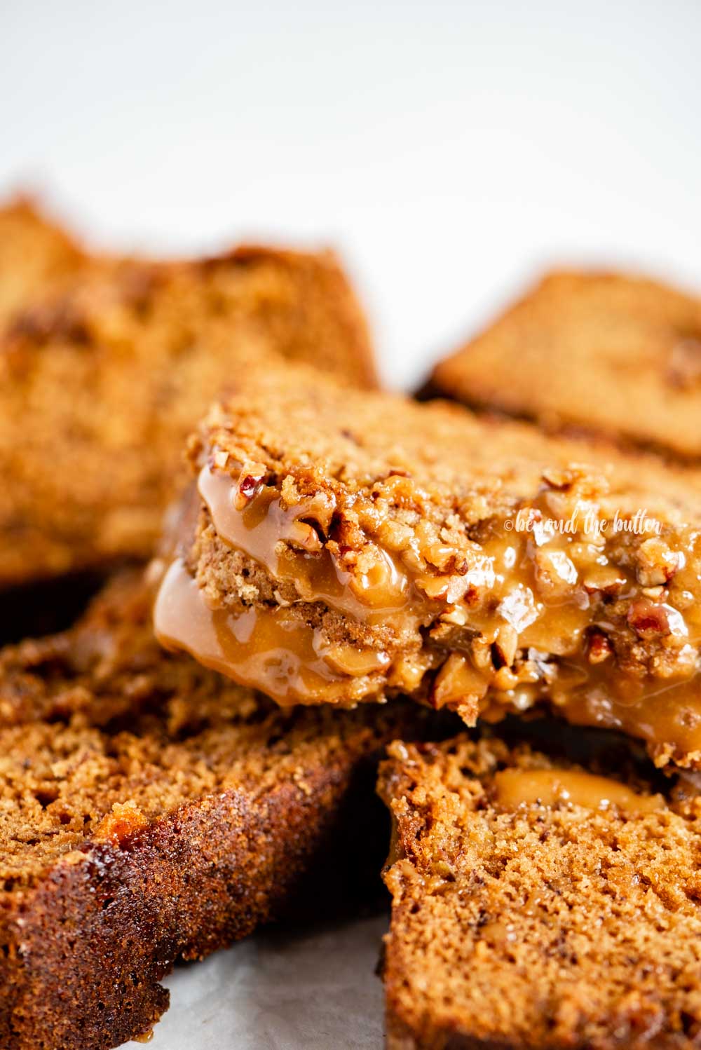 Closeup overhead image of slices of salted caramel banana nut bread on their side | All Images © Beyond the Butter™