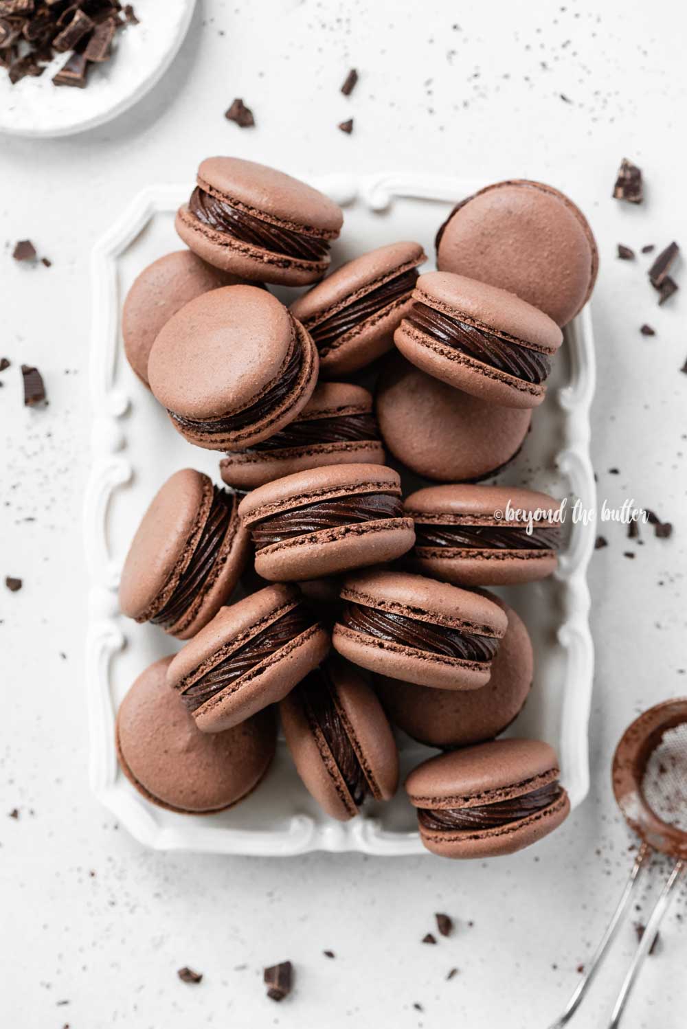 Plate full of dark chocolate macarons | All Images © Beyond the Butter™