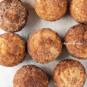 Overhead image of cinnamon sugar breakfast muffins on a white background | All Images © Beyond the Butter™