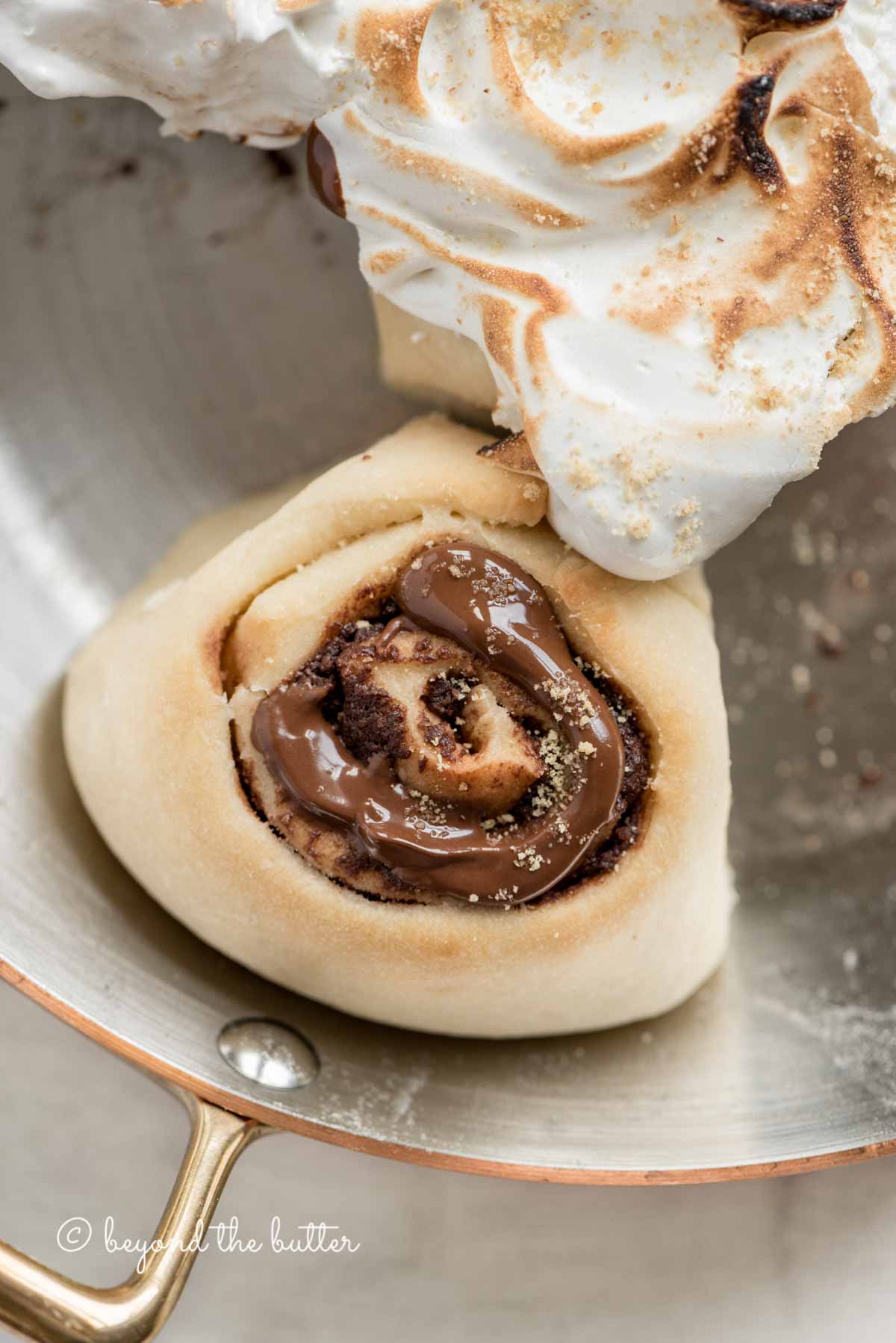 Overhead closeup image of s'mores rolls partially covered with marshmallow topping | All Images © Beyond the Butter™