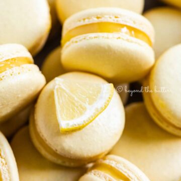 Close up of lemon bar macarons on side | All Images © Beyond the Butter™