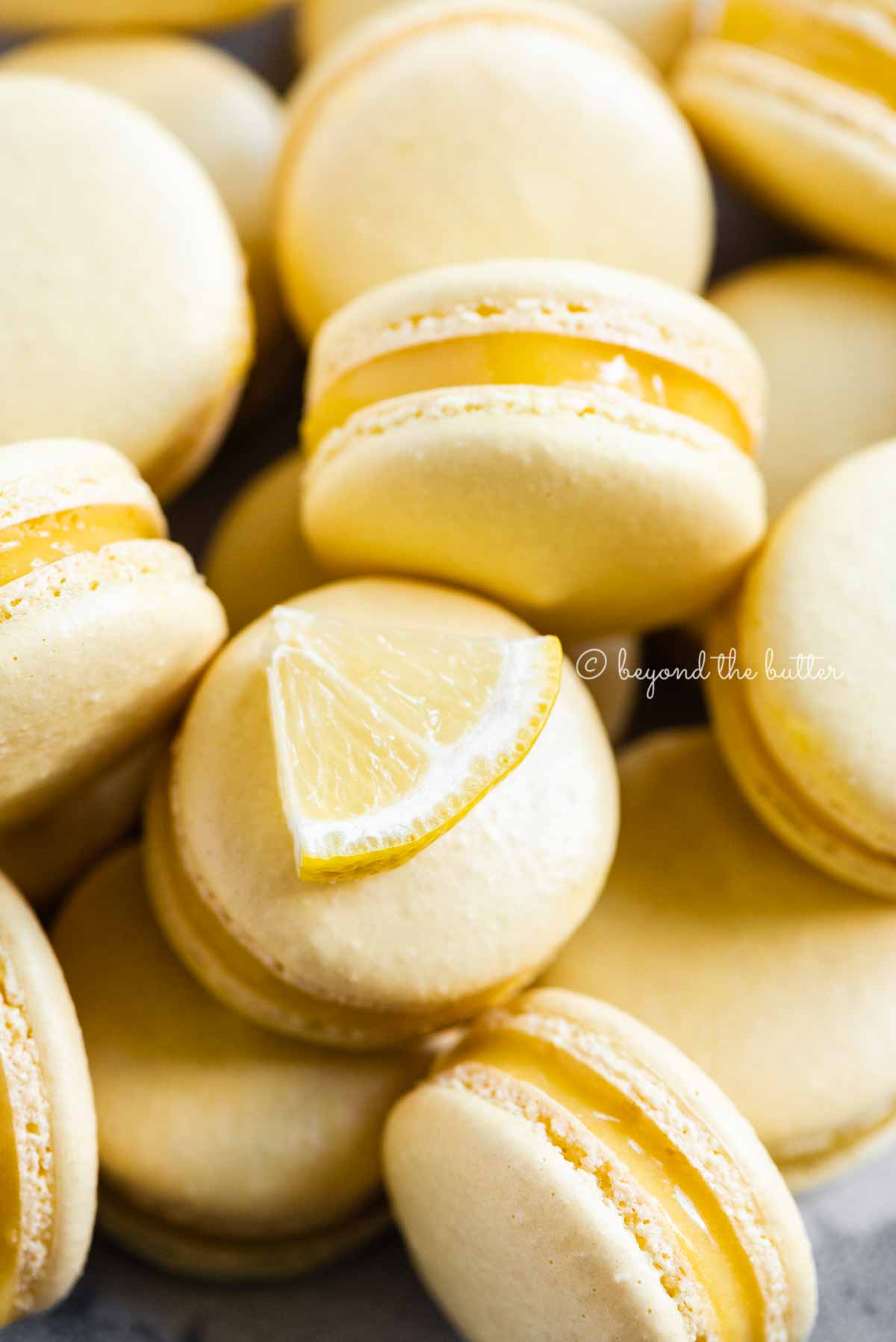 Close up of lemon bar macarons randomly placed.