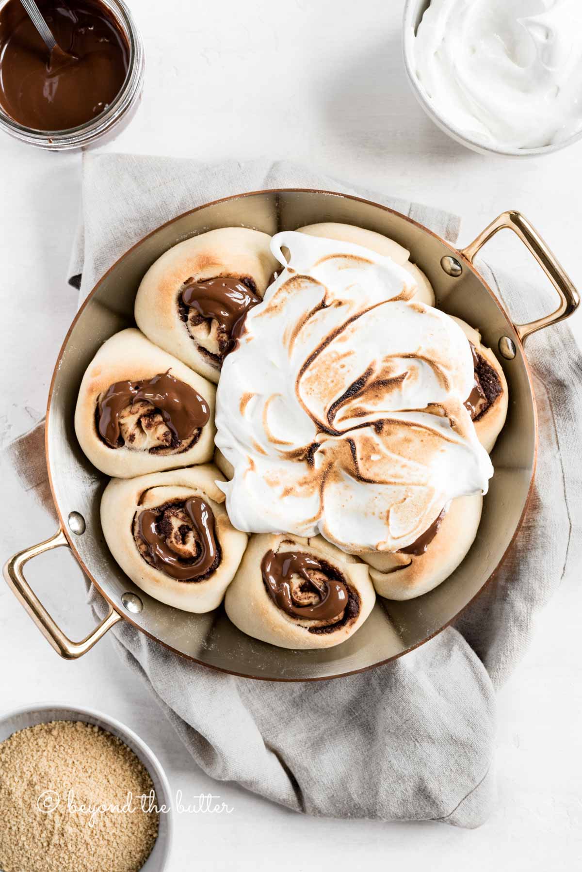 Overhead image of s'mores rolls partially covered with marshmallow topping | All Images © Beyond the Butter™