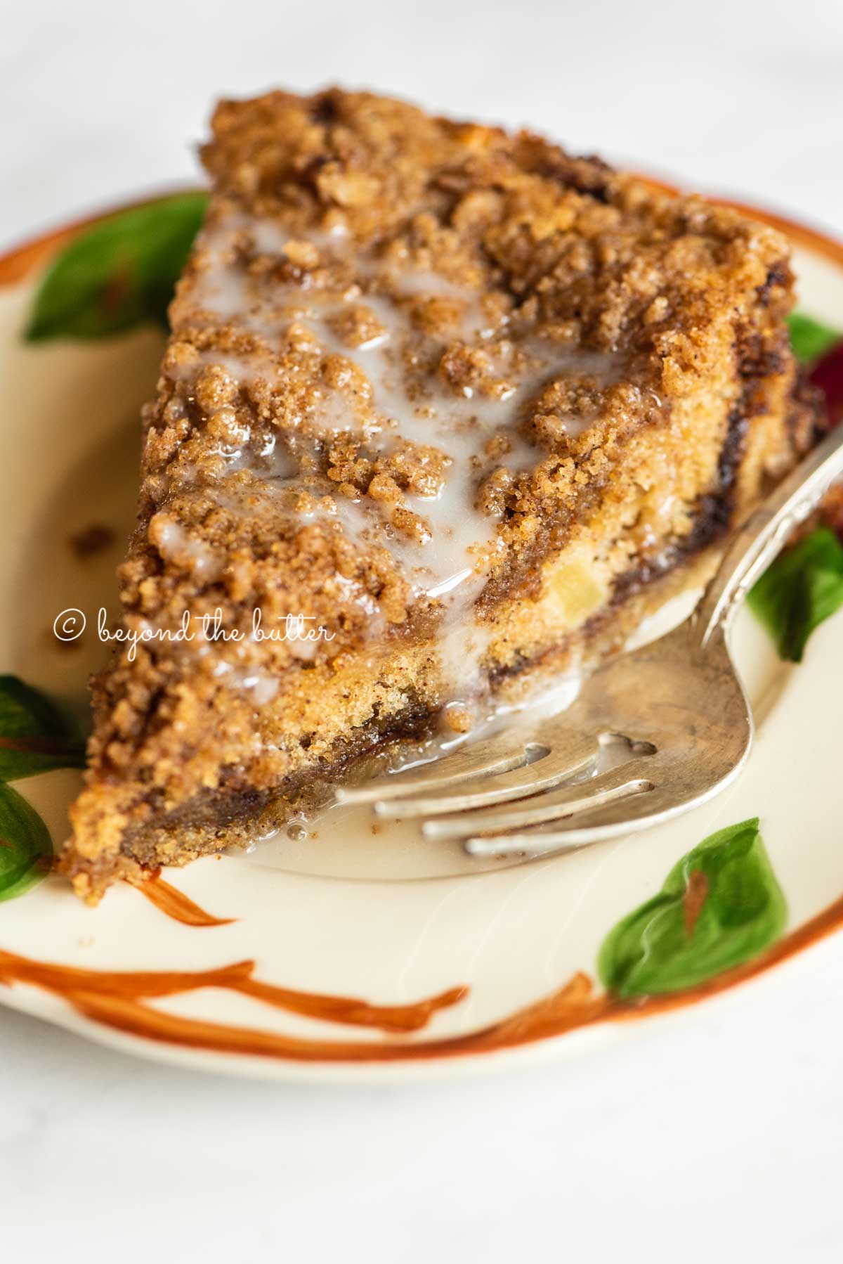 Slice of apple coffee cake on a dessert plate close up | All Images © Beyond the Butter™