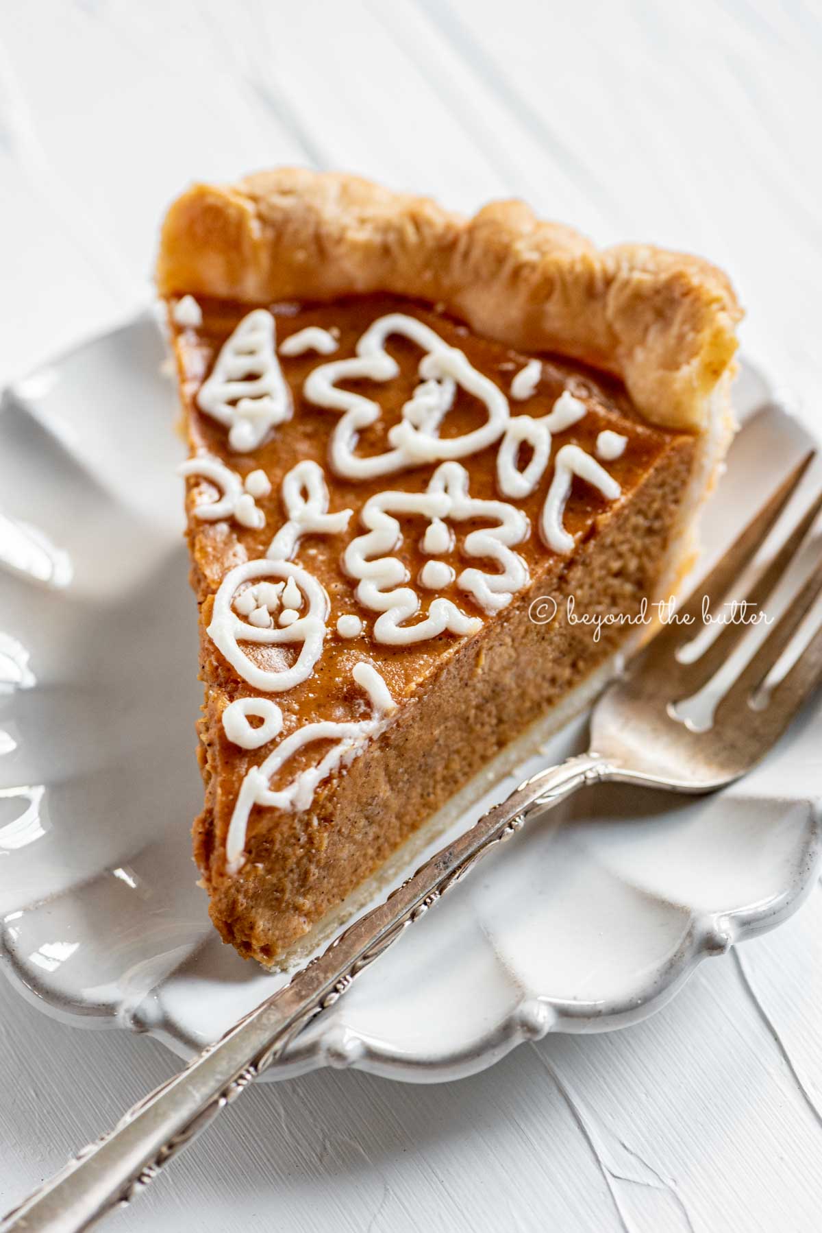 Slice of pumpkin pie on a dessert plate | All Images © Beyond the Butter™