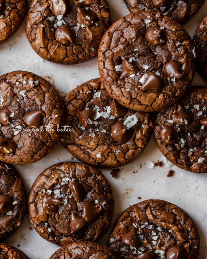 Salted brownie cookies on abstract light brown background.
