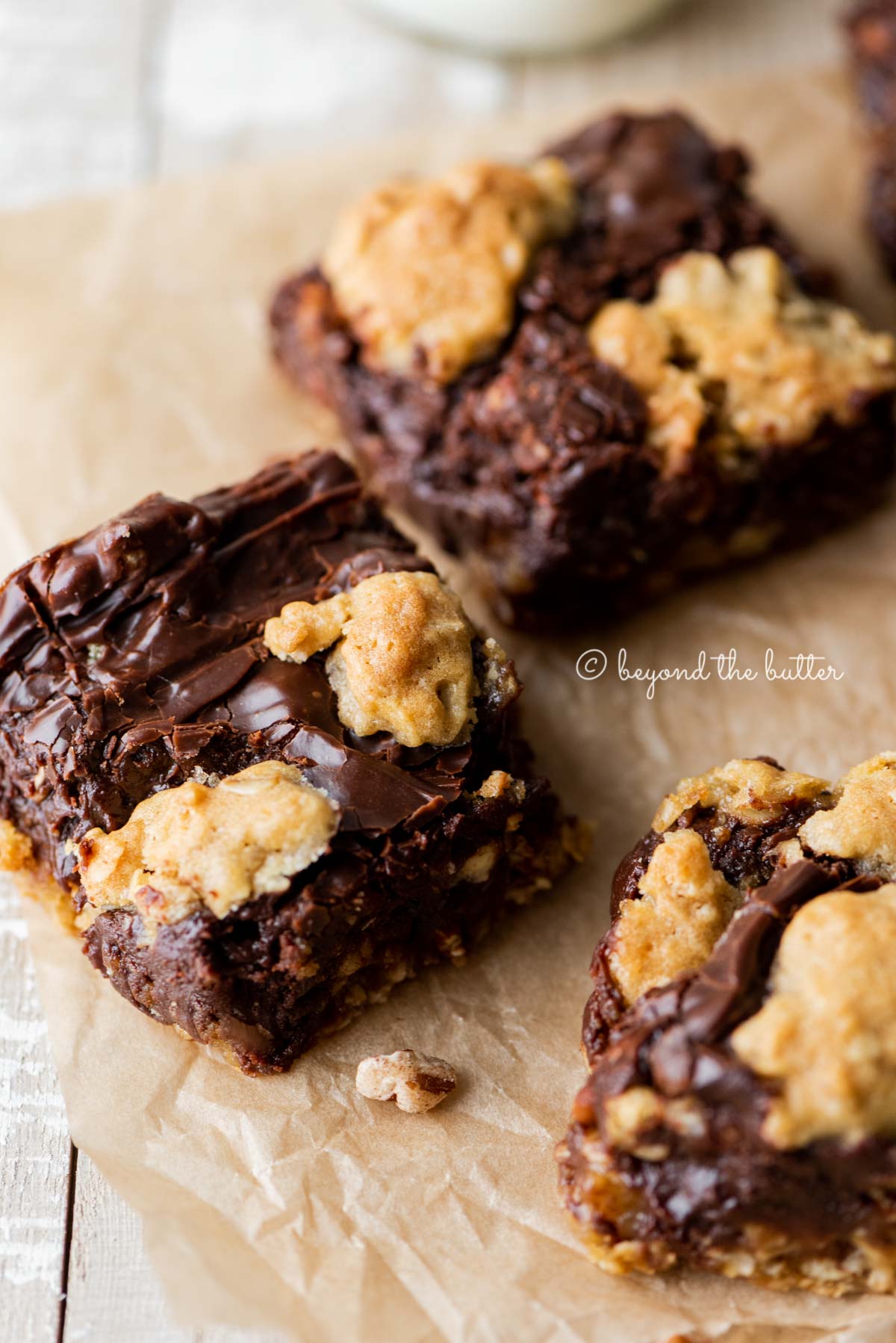 Classic oatmeal fudge bars on parchment paper | All Images © Beyond the Butter®