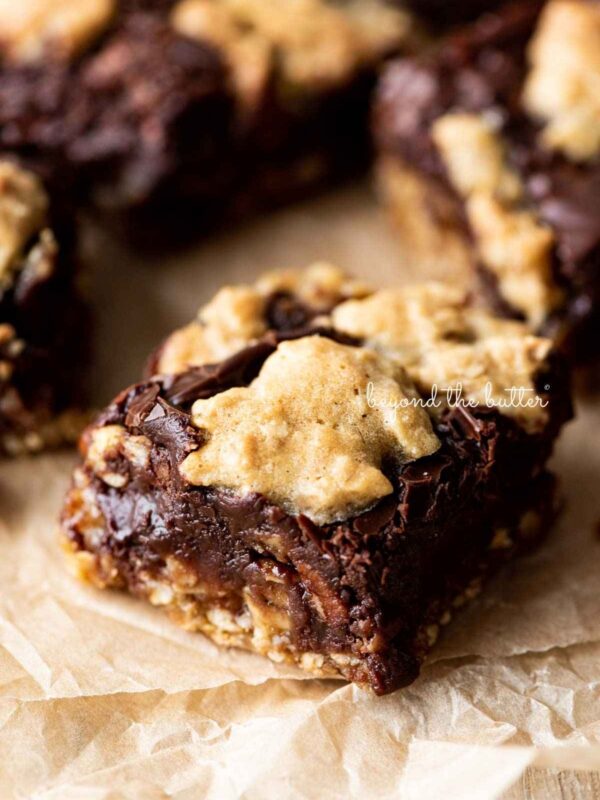 Oatmeal fudge nut bars randomly placed on crinkled brown parchment paper.