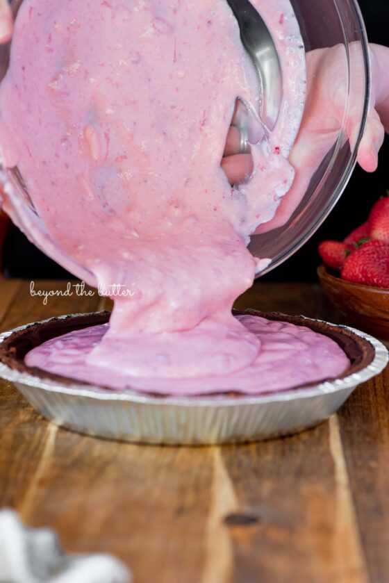 Pouring the strawberry pie filling mixture into the prepared Diamond of CA® chocolate nut pie crust | All images © Beyond the Butter®