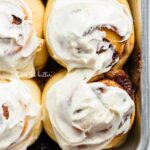 Frosted small batch cinnamon rolls on baking sheet.