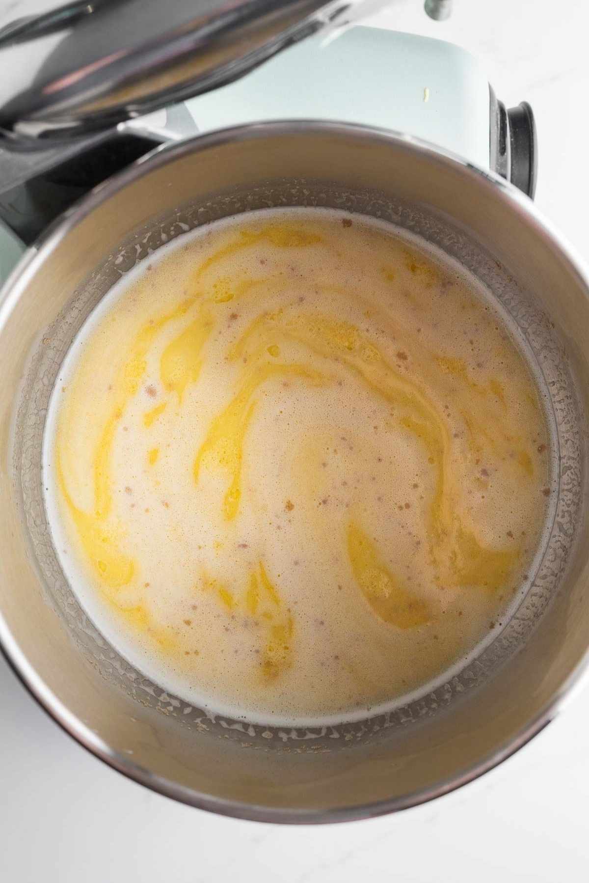 Yeast, egg mixture, and warmed milk whisked together in an Ankarsrum mixing bowl.
