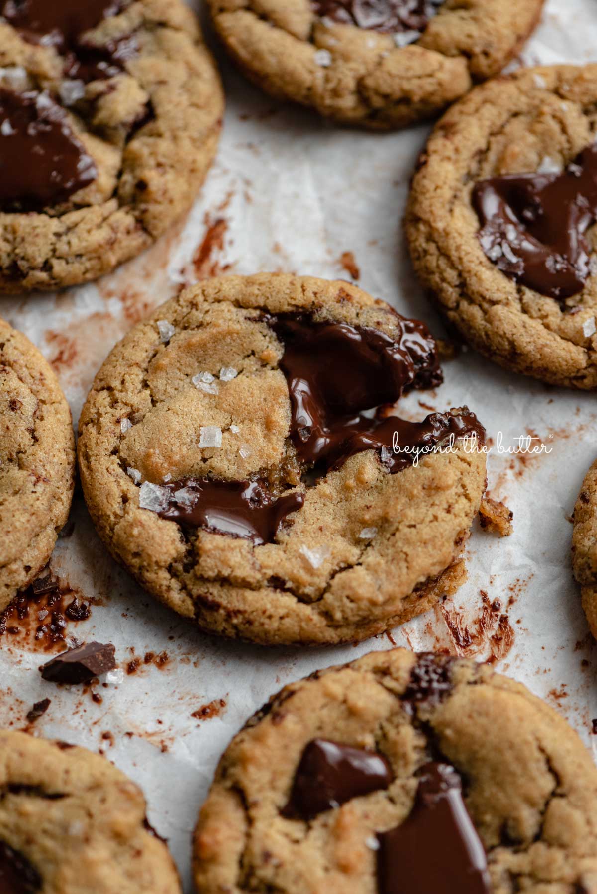 Small batch gluten-free peanut butter chocolate chunk cookies on a parchment paper lined baking sheet.