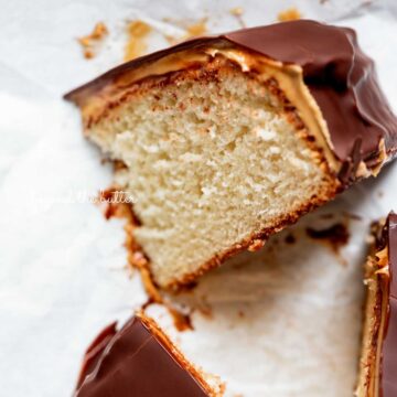 Small chocolate peanut butter tandy kake with a slice removed and placed on its side | © Beyond the Butter®