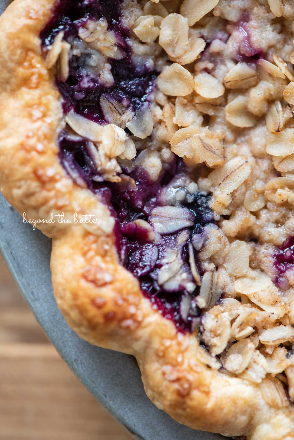 Upclose image of blueberry crumble pie crust edge | © Beyond the Butter®