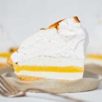 Slices of lemon meringue ice cream pie on dessert plates.