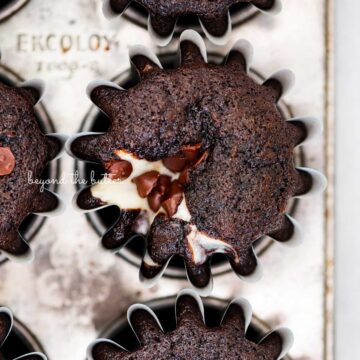 Vintage baking tin filled with small batch black bottom cucpakes from BeyondtheButter.com | © Beyond the Butter®