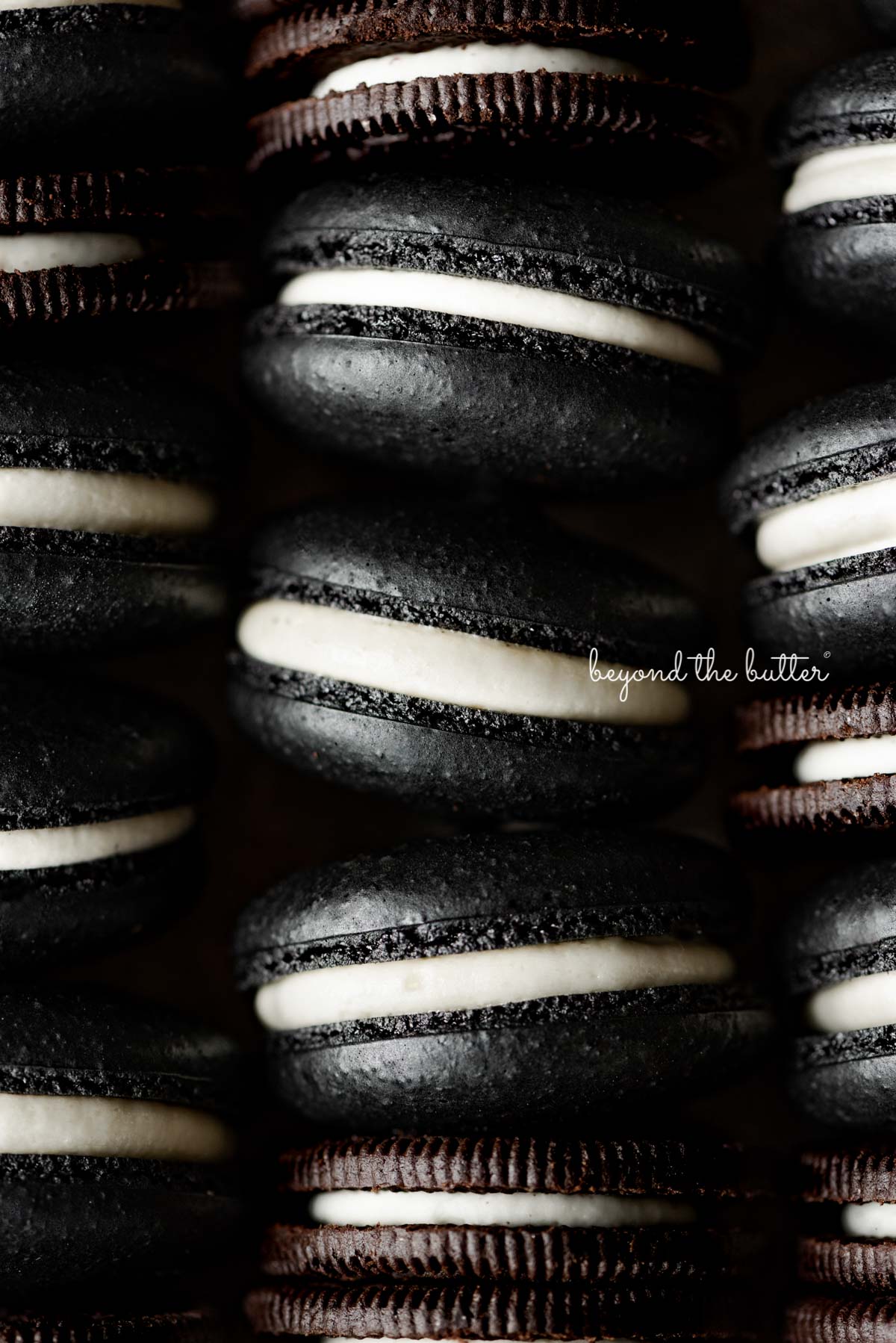 Stacked oreo macarons mixed with oreo cookies in a vintage baking tin | © Beyond the Butter®
