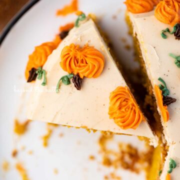 Slice of pumpkin spice cake on a black and white dessert plate | © Beyond the Butter®