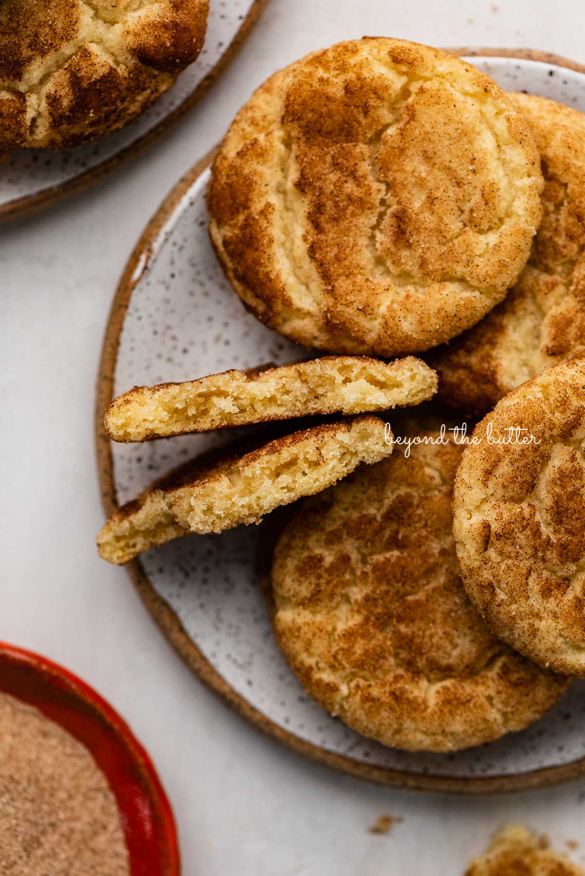 Plate of classic snickerdoodle cookies on white background | © Beyond the Butter®