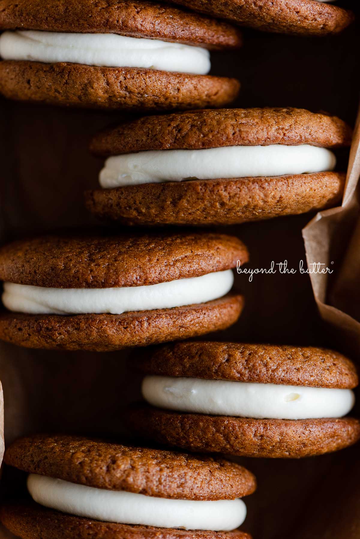 Gingerbread whoopie pies in a natural parchment paper lined ceramic pan | © Beyond the Butter®