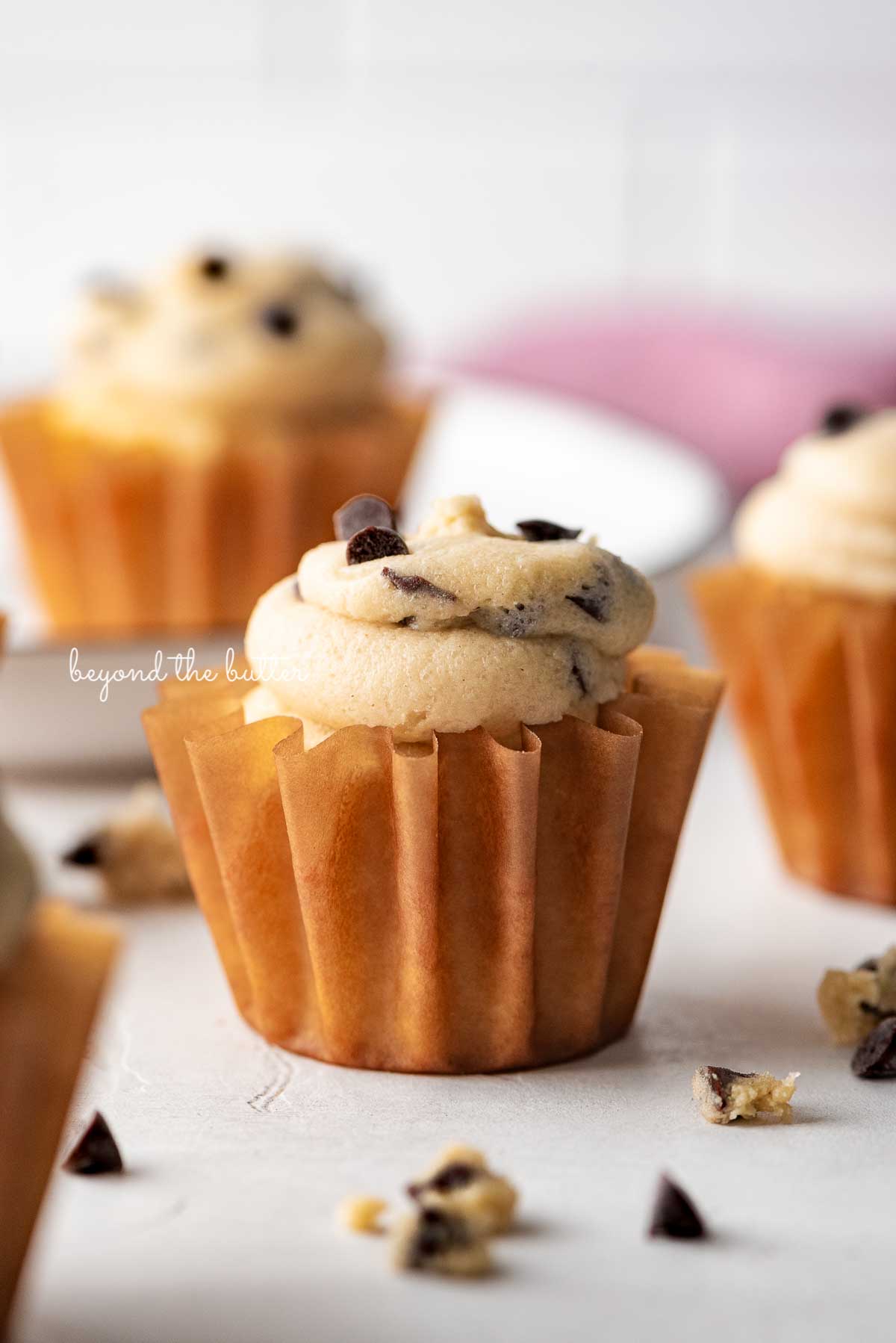 Small batch chocolate chip cookie dough cupcakes on a white marbled background | © Beyond the Butter®