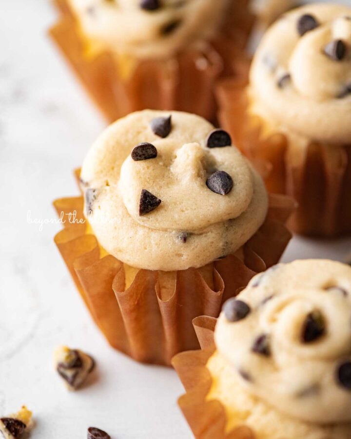Small batch chocolate chip cookie dough cupcakes on a white marbled background.
