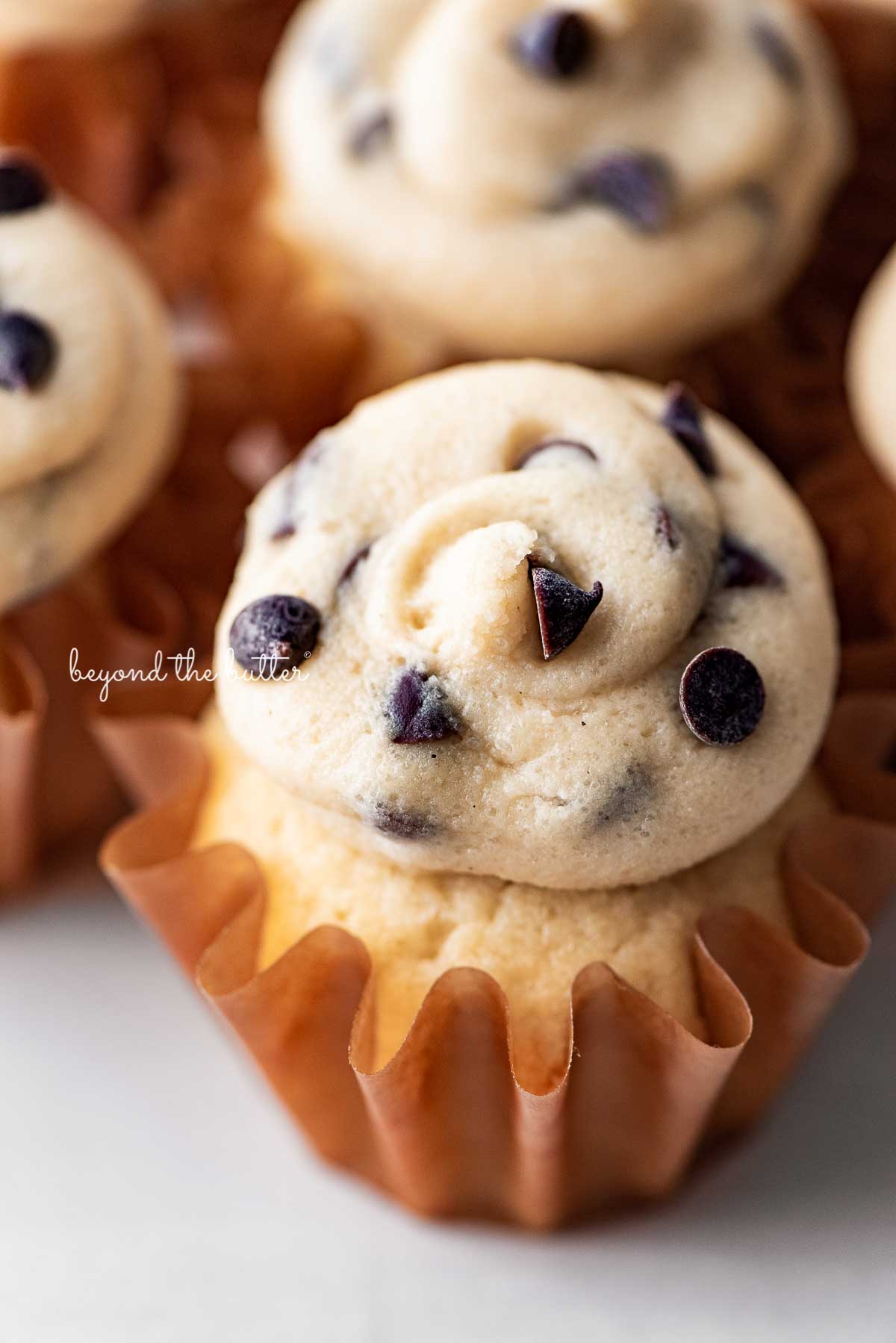 Close up image of small batch chocolate chip cookie dough cupcakes on a white marbled background | © Beyond the Butter®