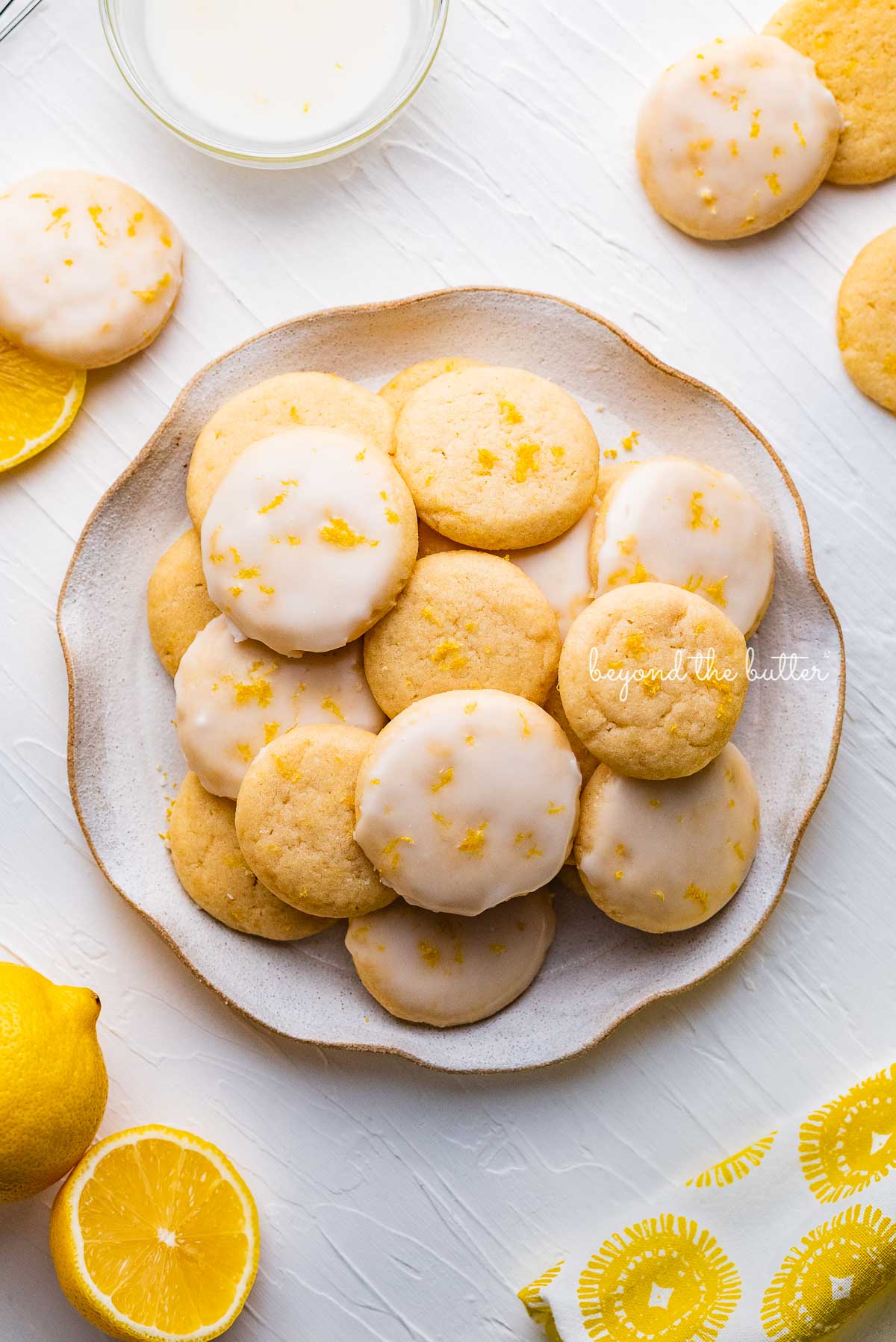 Plate full of lemon shortbread cookies | © Beyond the Butter®