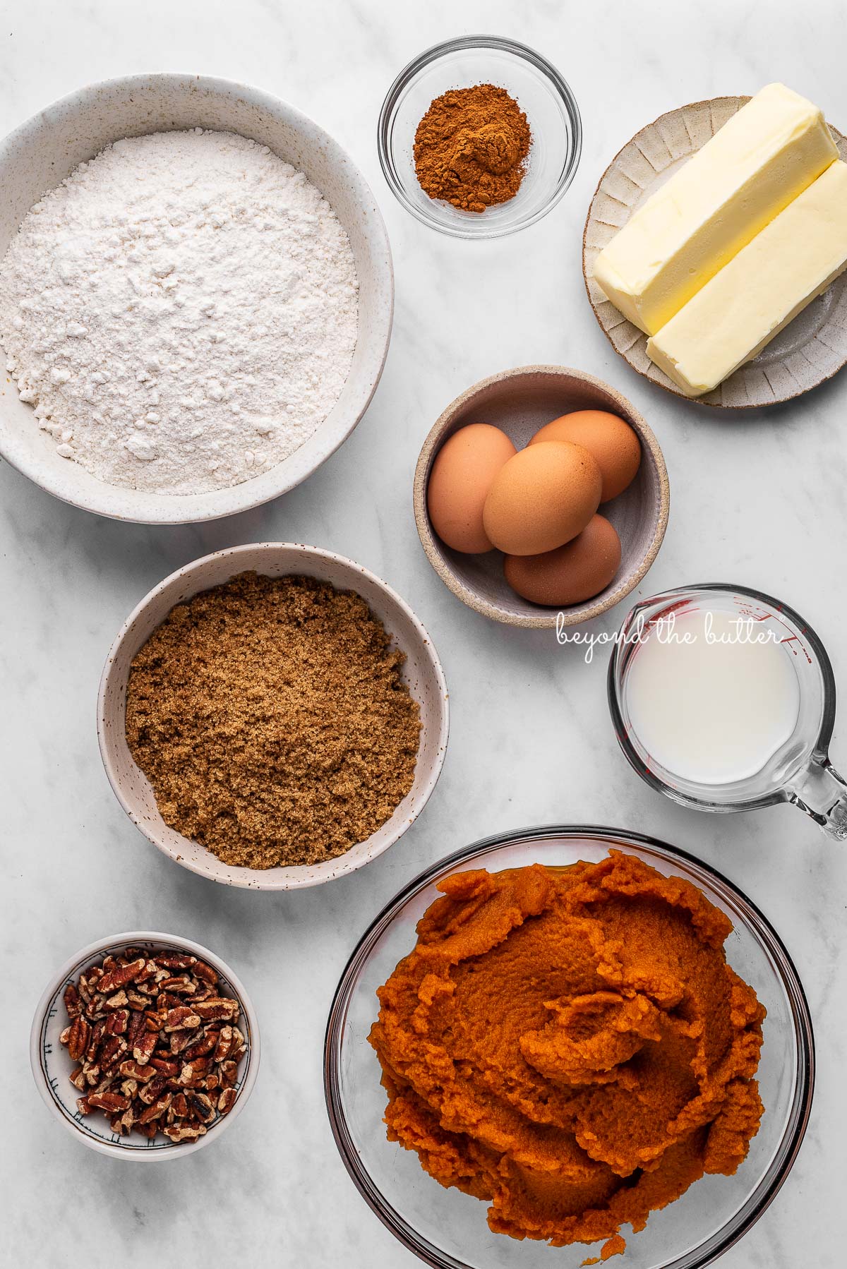 Ingredients of pumpkin pie cake bars on white marbled background | © Beyond the Butter®