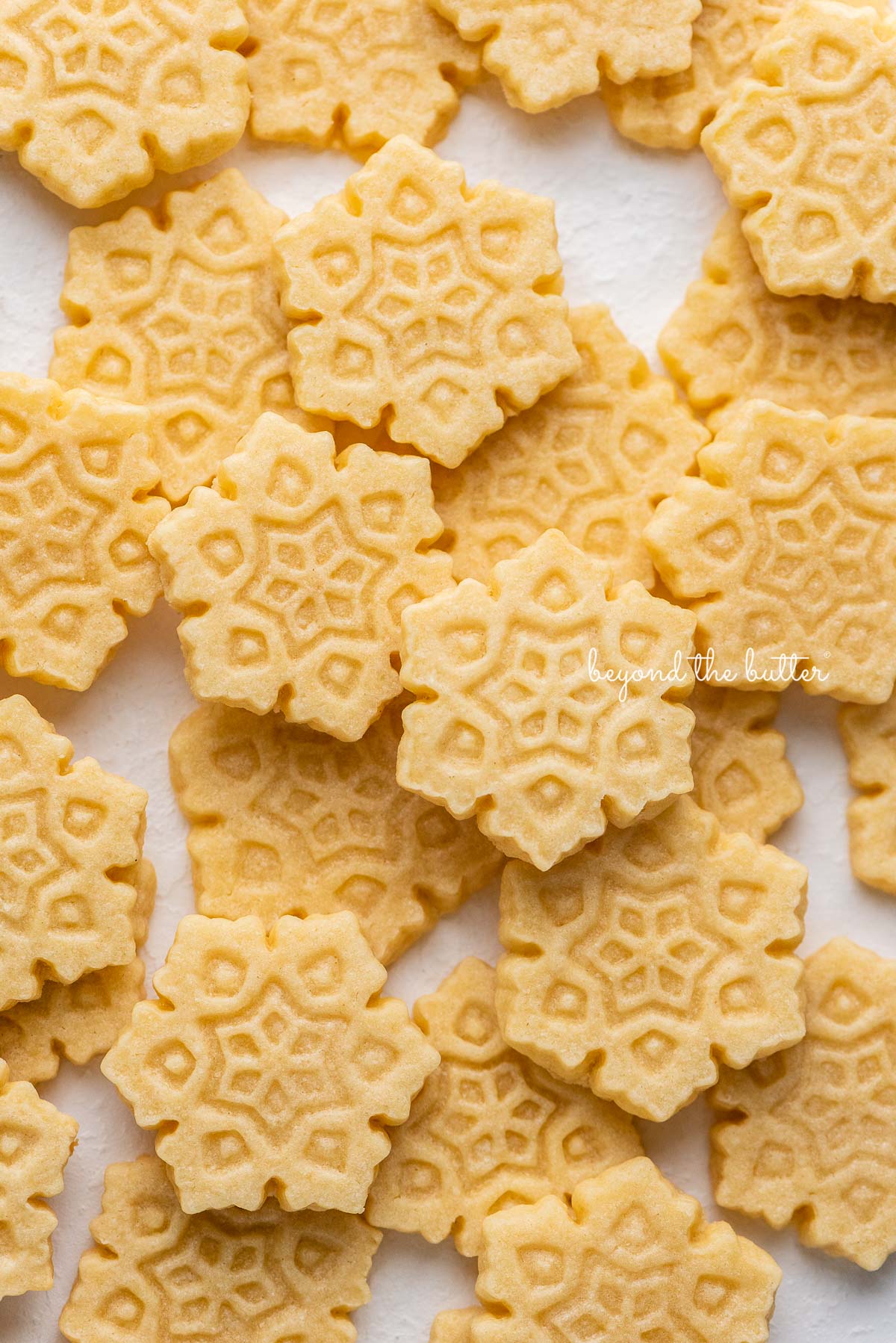 Randomly placed homemade butter cookies on a white background | © Beyond the Butter®